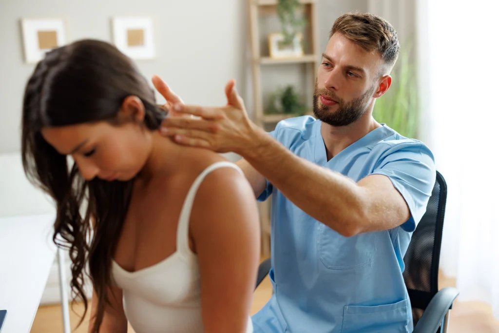 Chiropractor providing spinal adjustment to help a patient with back pain at Tailor Made Wellness in Sherwood Park