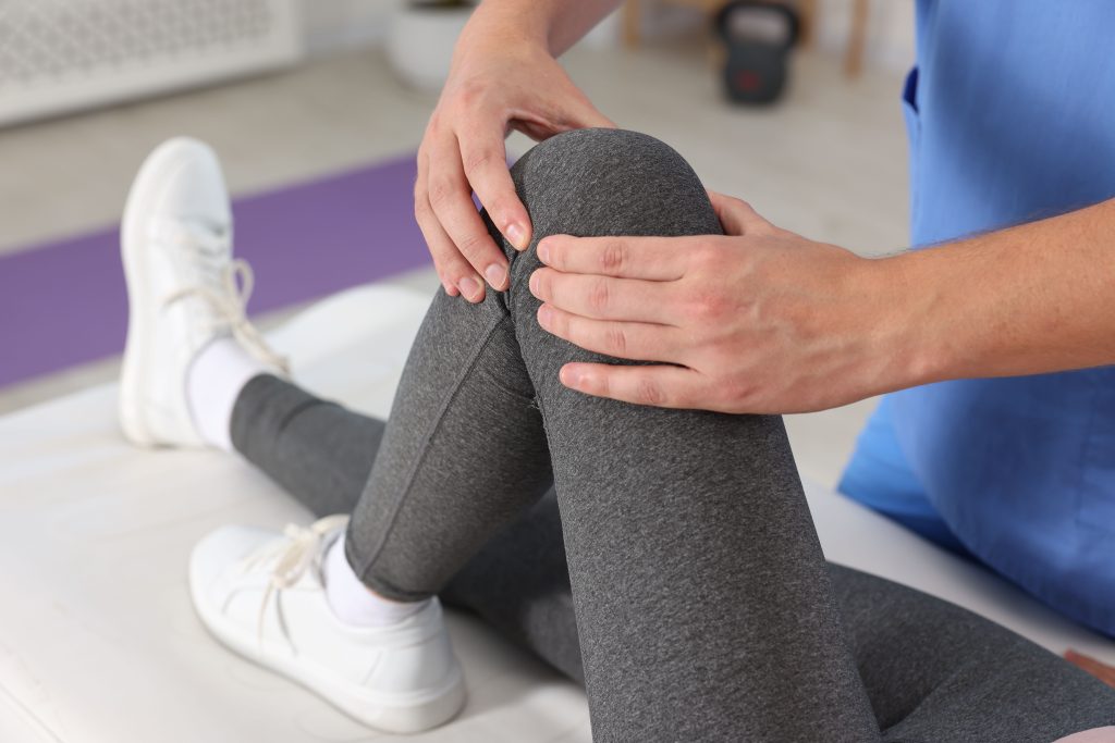 physiotherapist working with knee pain
